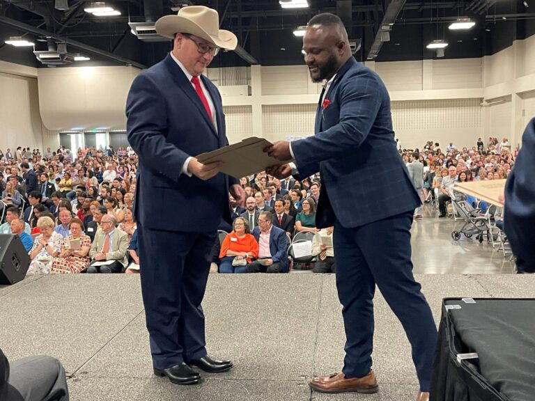 Omoruyi accepting certificate at ceremony